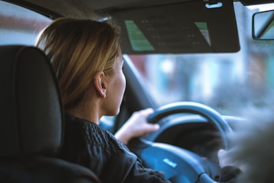 Having a teenager start driving makes any parent nervous. Not just out of worry for their safety but also out of worry for your auto insurance rates. By setting some basic ground rules from the start, you can protect both your teenager and your car insurance rates. 1. Follow the Lawa woman sitting in a car with a steering wheel This sounds simple, but think about how you drive. Speeding, rolling red lights or stop signs, following too close to keep other drivers out of your lane, using your cellphone and other bad habits all set an example for your teenager. You may think that your bad habits are no big deal, but deep down inside, you probably know they're at least a little dangerous. With an inexperienced teen driver, they can become even more dangerous. 2. No Phones at All No matter what your state law says about phone use while driving, don't let your teenager use a phone in any way. Even a hands-free voice call can add distractions that a new driver just doesn't need. While millions of drivers may do it successfully every day, your goal is still to eliminate distractions. 3. Set a Curfew to Leave Not Arrive If you give your teenager a specific time to get home by, you risk them speeding or taking other dangerous measures to get home on time. You may say they should have left earlier, but they're still going to leave late and try to keep you from finding out. Set a time they need to leave to head home instead. 4. Amnesty if They Can't Drive Home There's a chance your teenager may be at a party with alcohol. You don't want them to risk driving drunk home and trying to sneak in. While you may be upset at them for drinking, they need to know they can call you if they need to get home safely. 5. No Passengers New drivers shouldn't have passengers for the first several months. When you were in the passenger seat teaching them to drive, you were helping them learn and forcing them to be more attentive. Friends create a distraction and, directly or indirectly, encourage risk-taking behaviors to seem cool. By following these rules, you'll increase the chances of your teenager getting home safely and not increasing your car insurance rates.