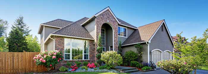 Suburban two-story house with brick facade and landscaped front yard -  https://keatsagency.com/