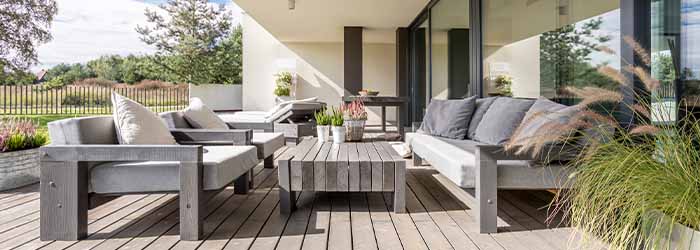 Grey outdoor patio furniture on wooden deck - keatsagency.com